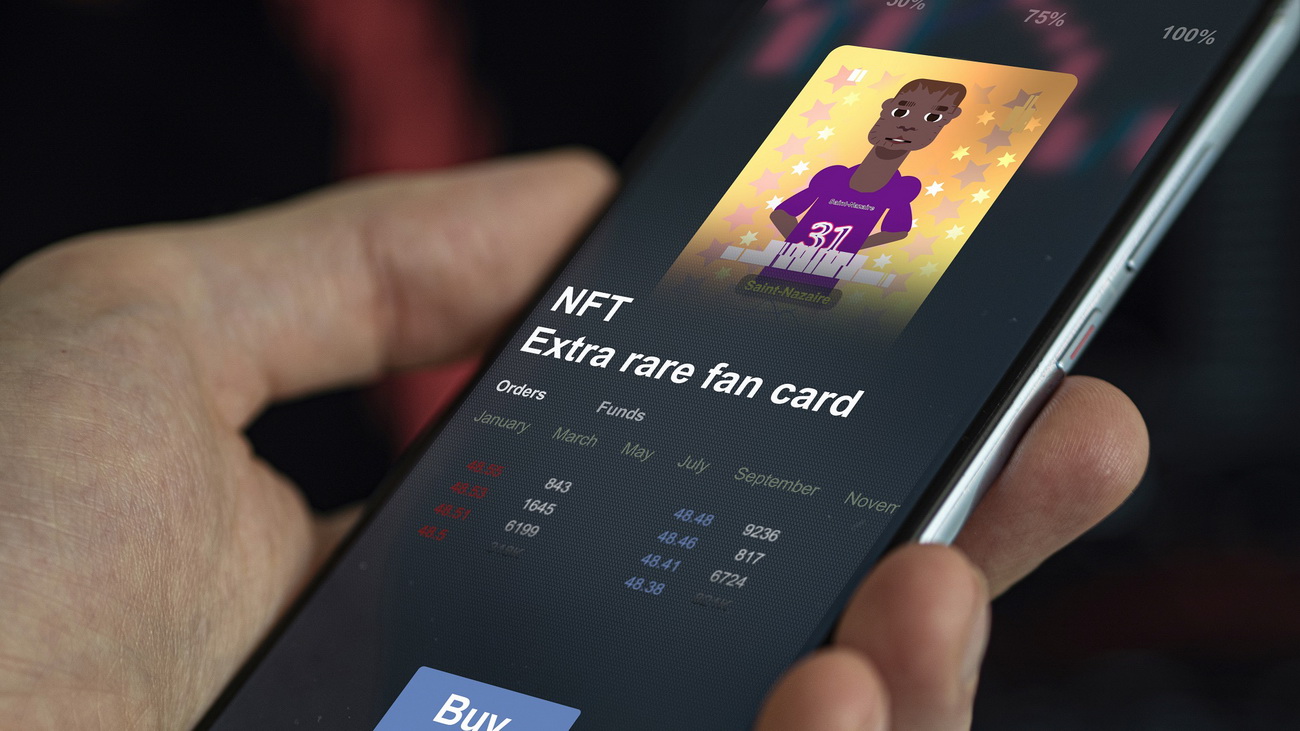 A smartphone user holds a device with an image of a sports player on it. Text reading ldquo;NFT Extra Rare Fan Cardrdquo; is displayed below the image, along with a ldquo;Buyrdquo; button.